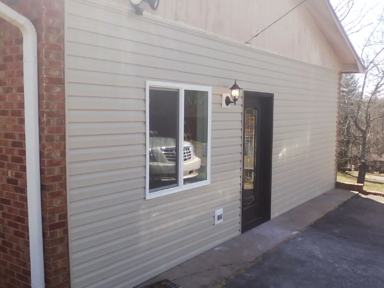 New vinyl siding and entry door on a room addition in Thomasville
